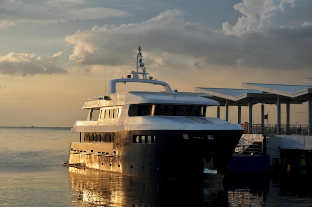 Maynila Yacht Club and ferry service terminal for filipino people and foreign travelers passenger journey visit use service travel visit at Roxas Boulevard road sunset dusk time in Manila Philippines