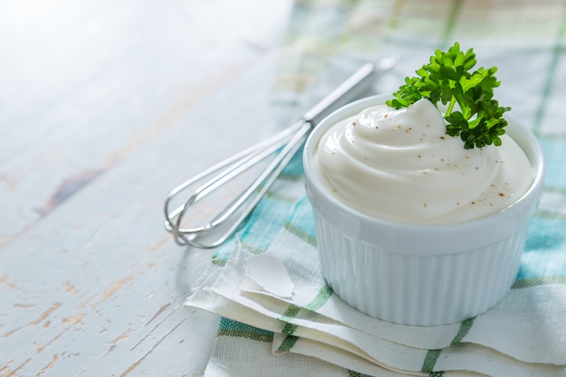 Mayonnaise sauce on wood background