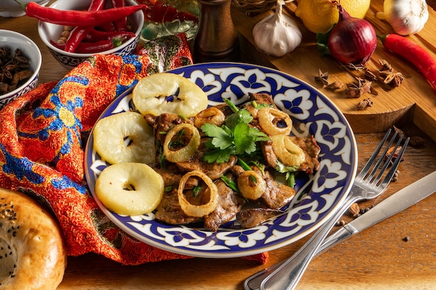 Mazza. Hot Uzbek dish of lamb liver, with the addition of baked apples, paprika, garlic, coriander, green onions and soy sauce.