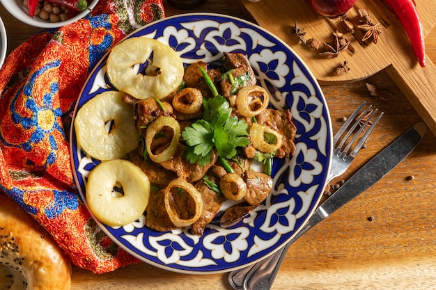 Mazza. Hot Uzbek dish of lamb liver, with the addition of baked apples, paprika, garlic, coriander, green onions and soy sauce.