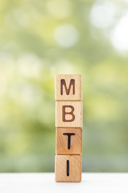 MBTI word is written on wooden cubes on a green summer background