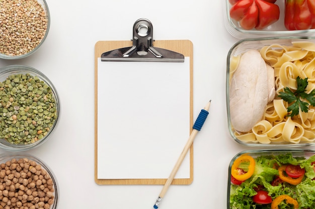 Meal planning clipboard and food assortment