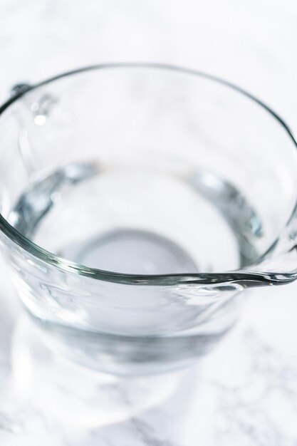 Measuring glass cups filled with water for preparation