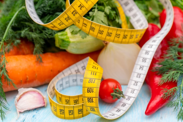 Measuring tape for measuring the circumference. Vegetables for diet cooking.