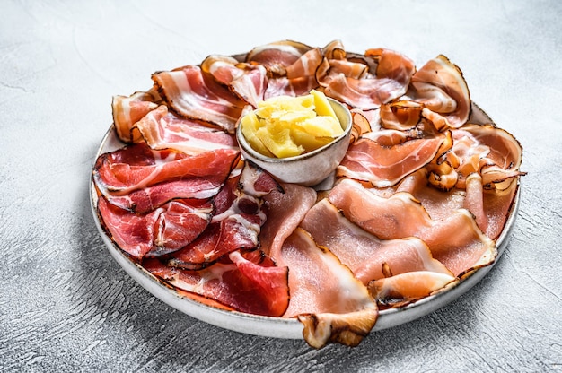 Meat antipasto platter, pancetta, salami, sliced ham, sausage, prosciutto, bacon