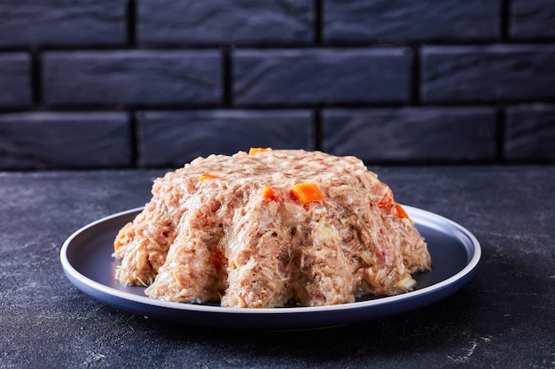 Meat aspic jellied slow cooked meat on a plate