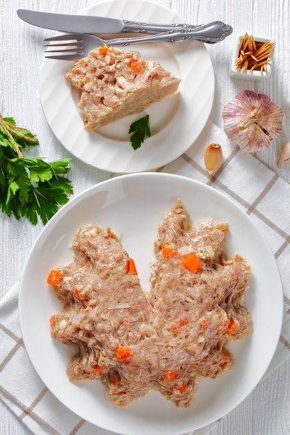 Meat aspic jellied slow cooked meat on a plate