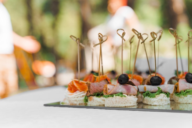 Meat canapes on white table on catering for company