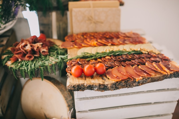 Meat, cheese and nutmeg wedding buffet with various snacks.