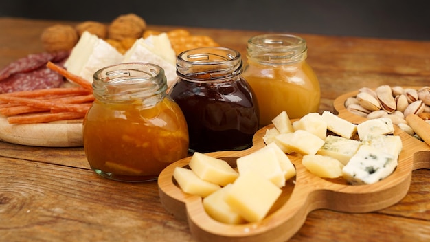 Meat and cheese plate for appetizers jars with jam and honey