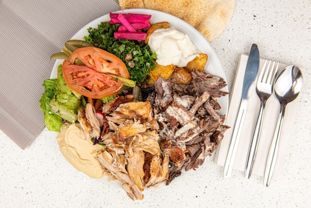 Meat and chicken mix Shawarma Doner on a plate Meat and chicken mix Shawarma plate isolated on white background