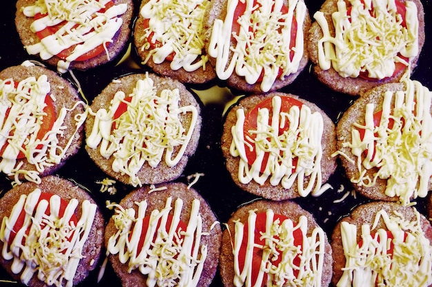 Meat chops with tomatoes are ready for baking in the oven Top view