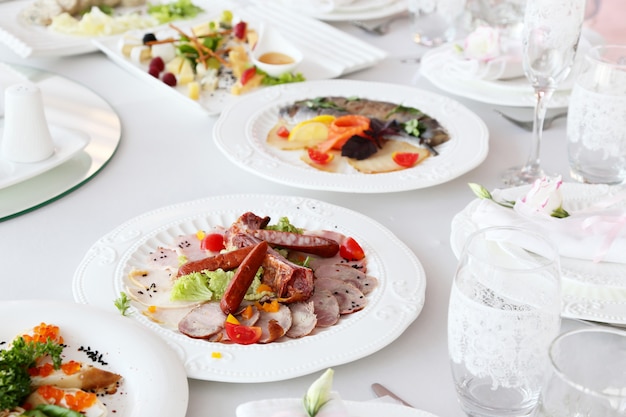 Meat cold cuts, sausages on a banquet table