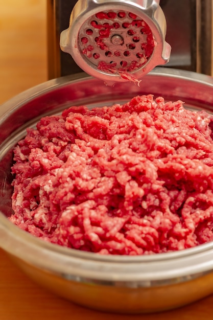 Meat and grinder. Minced meat and meat grinder. Meat grinder machine chopping uncooked ground meat.