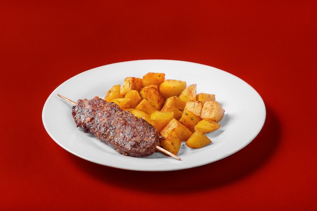 Meat kebab with fried potatoes for the menu