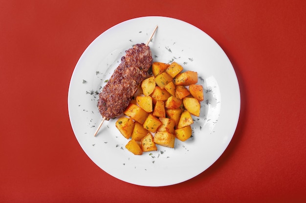 Meat kebab with fried potatoes for the menu