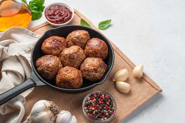 Meat meatballs spices and sauce on a gray background