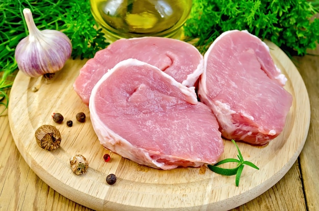 Meat pork slices on a board with nutmeg