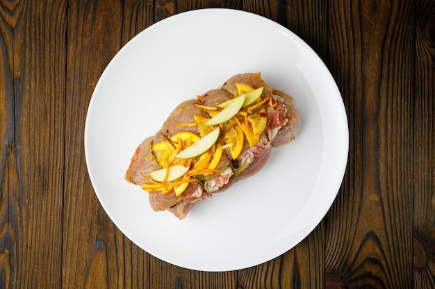 meat products on a white plate on a wooden table