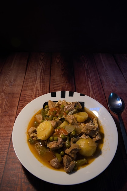 Meat stew on your plate on a wooden background world food day concept