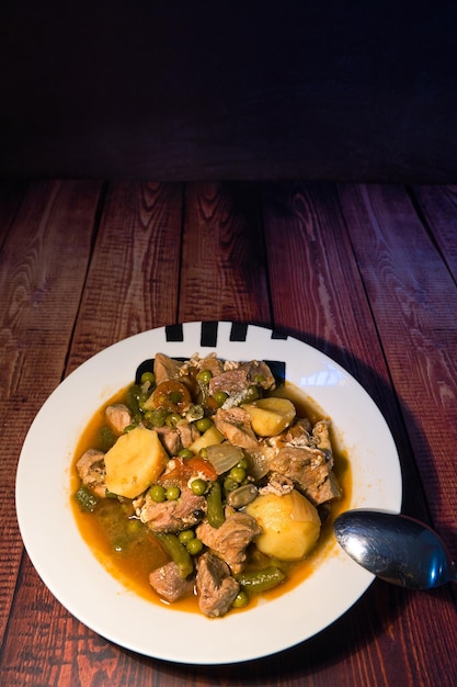 Meat stew on your plate on a wooden background world food day concept