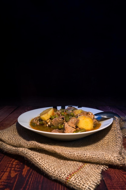 Meat stew on your plate on a wooden background world food day concept