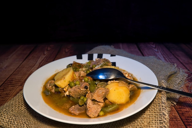 Meat stew on your plate on a wooden background world food day concept