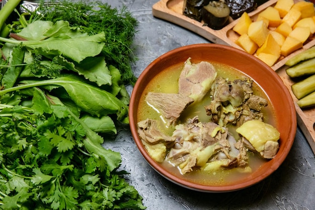 Meat with potato stew served on plate on dark background