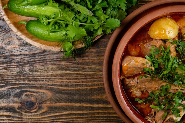 Meat with potato stew served on plate on dark background