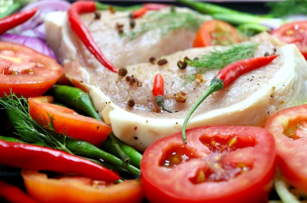 Meat with spices onions red and green peppers ginger tomatoes