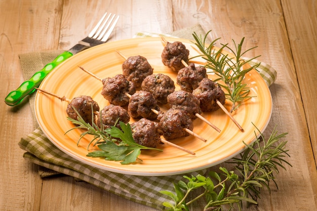 Meatballs skewers with herbs