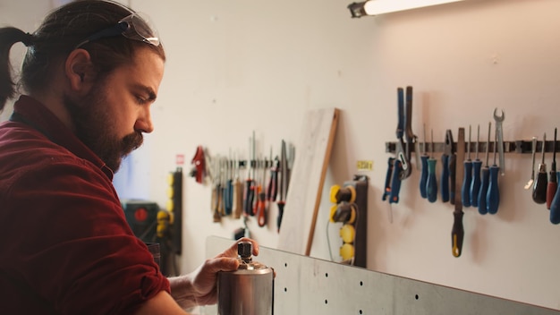 Mechanic in carpentry shop changing rotor part on spindle moulder