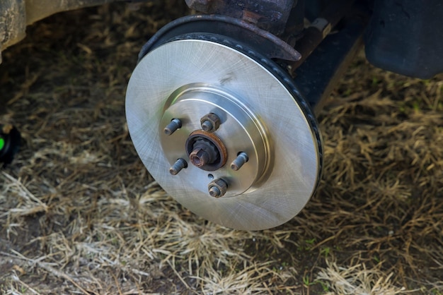 Mechanic change the old drive to the new brake disc on car with repairing