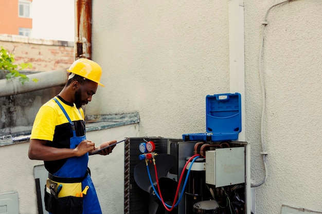 Mechanic doing air conditioner checkup