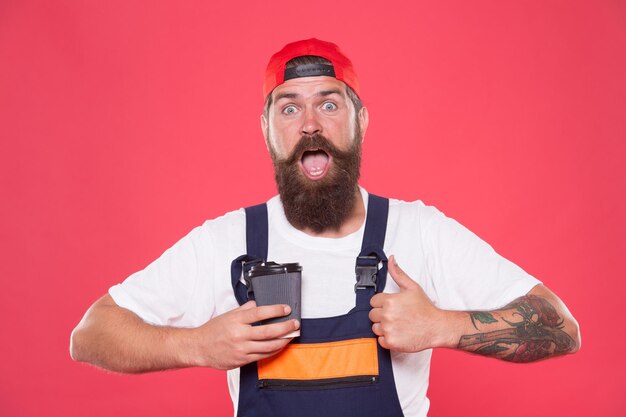 Mechanic enjoy coffee Coffee helps enhance productivity levels increases focus and lowers stress levels at work Handsome builder hold coffee cup Is Coffee Break the Best Part of Your Day