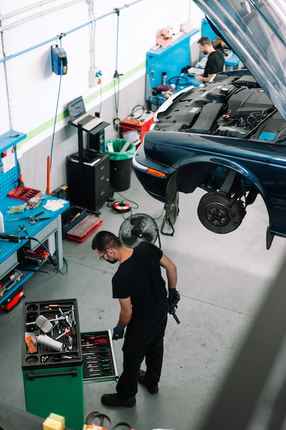 mechanic fixing car in auto repair shop