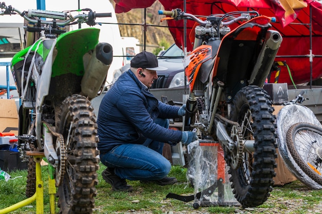 Mechanic fixing motocycle wheel