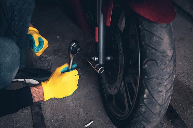 Mechanic fixing a motorcycle in the garage