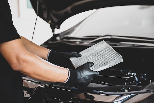 Mechanic hand is holding car air filter