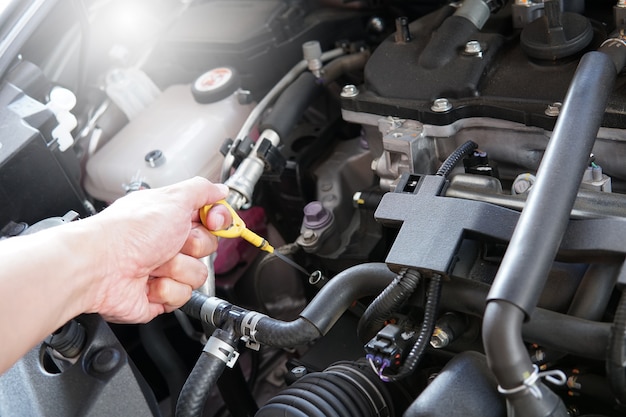 Mechanic man working and repair car engine in car service centre.  