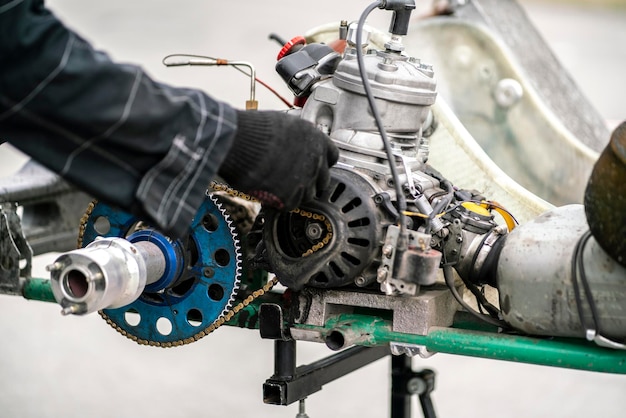 A mechanic repair the karting engine in workshop