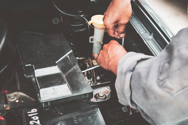 Mechanic in repairing car and check the engine daily before use. 