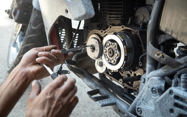 Mechanic repairing engine of motorcycle Concept of motorcycle maintenance