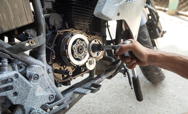 Mechanic repairing engine of motorcycle Concept of motorcycle maintenance