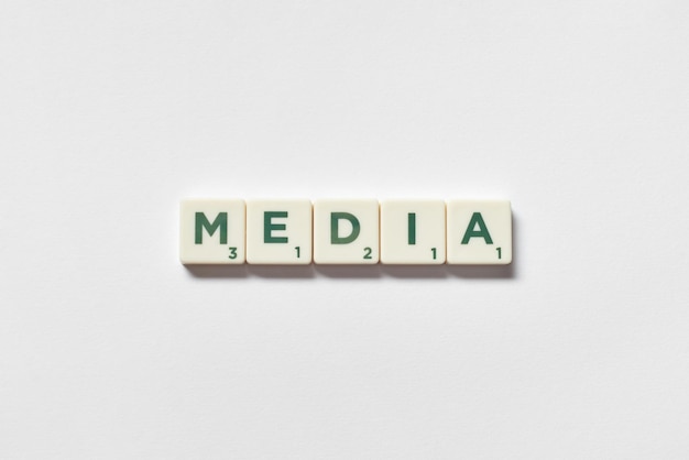 Media formed of scrabble blocks on white background