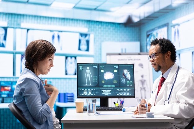 Medic expert showing the x ray imaging test results to patient at check up