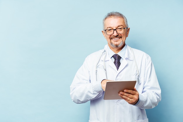 A medic holds a tablet in his hands