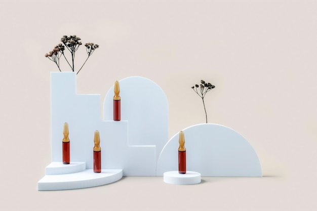 Photo medical ampoules on a podium made of geometric shapes and twigs of dried flowers on a beige background