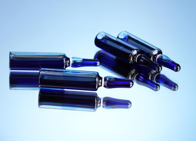 Medical ampules on blue background