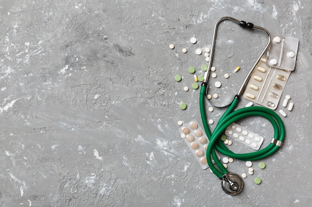 Medical background Many different various medicine tablets or pills on the table with stethoscope Close up Healthcare pharmacy and medicine concept